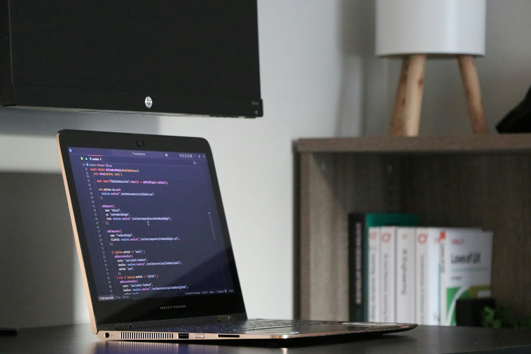 Laptop displaying software code in a development workspace